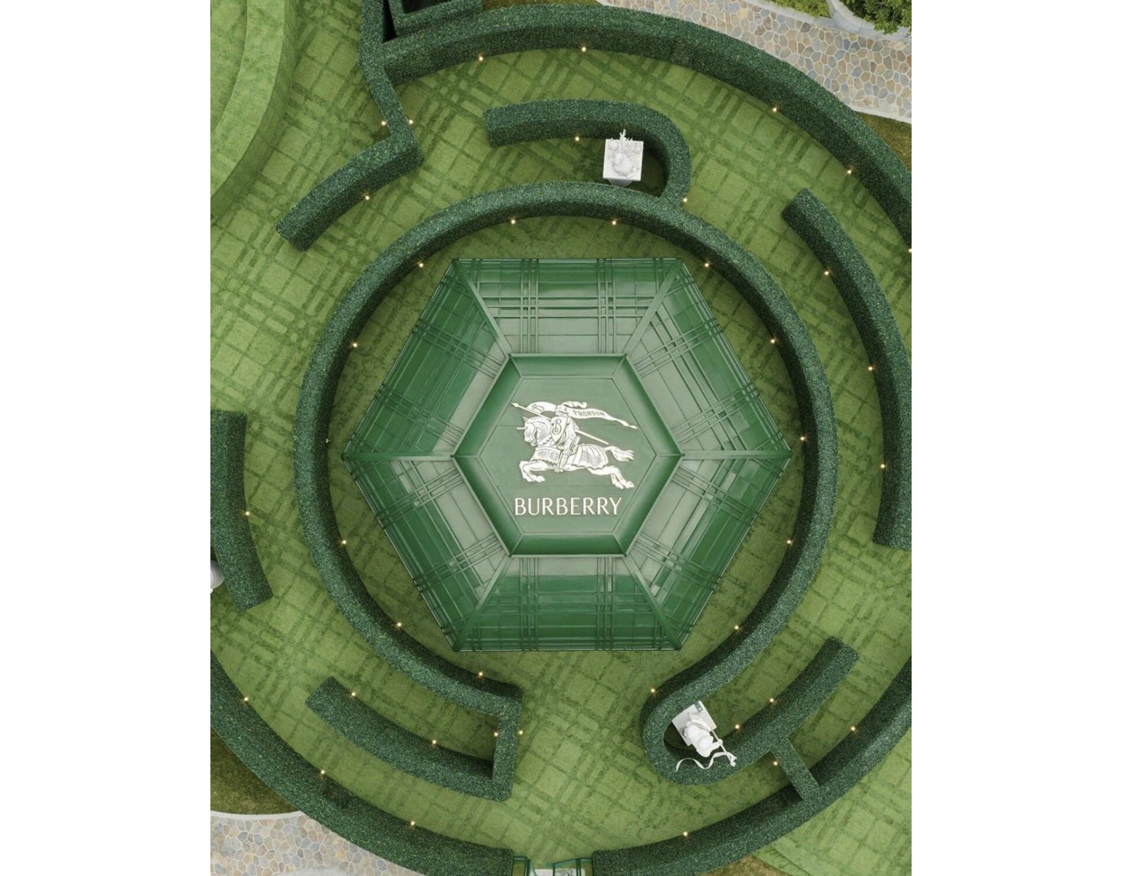 Aerial view of Burberry hexagonal glass pavilion and hedge maze pop-up installation in China